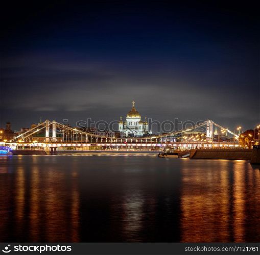 Night view at the main Russian Cathedral of Christ the Savior and the Krymsky Bridge from the embankment of Gorky Park, Moscow, Russia