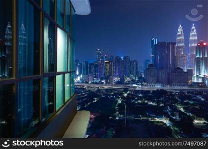 Night view of a beautiful cityscape with window reflection
