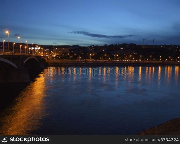 Night view of Budapest river with night lights and reflections.