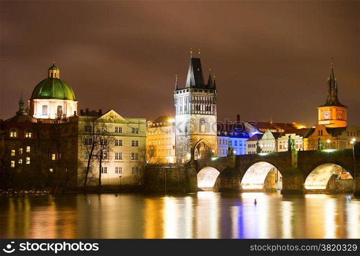 Night view of Charles bridge and Church of St. Francis in Prague