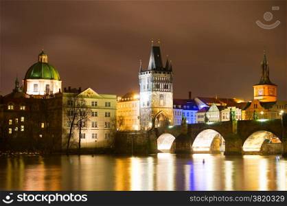 Night view of Charles bridge and Church of St. Francis in Prague