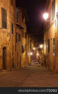 Night view of medieval street in Siena, Italy