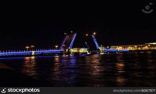 Night view of Neva River and raised Palace Bridge in St. Petersburg, Russia