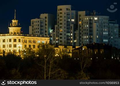 Night View of the city of Khabarovsk from the Amur river. Blue night sky. The night city is brightly lit with lanterns. Khabarovsk, Russia - Oct 24, 2019: Night View of the city of Khabarovsk from the Amur river. Blue night sky. The night city is brightly lit with lanterns.