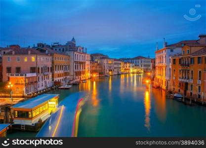 Night view of the Grand Canal and the Vaporetto stop from Accademia Bridge in Venice, Italy