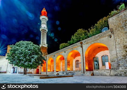 Night view Sehidiye Mosque and Madrassa though arch,a popular landmark in Mardin,Turkey.. Sehidiye Mosque and Madrassa in Mardin, Turkey