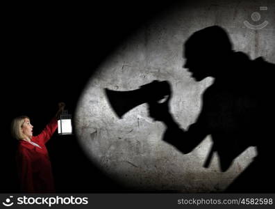 Nightmare. Young blond woman in red cloak with lantern