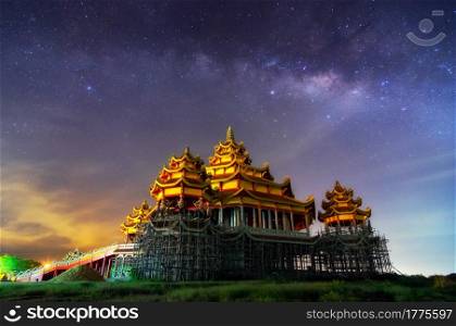 Nightscape Milky way galaxy with stars and space dust in the universe, long speed exposure over sanctuary Guan Yin with Chinese style in Phetchaburi Thailand.. Milky way
