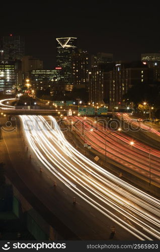 Nightscape of Atlanta, Georgia skyline with blurred automobile lights on highway in foreground.