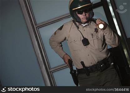 Nightwatch patrolman with flashlight