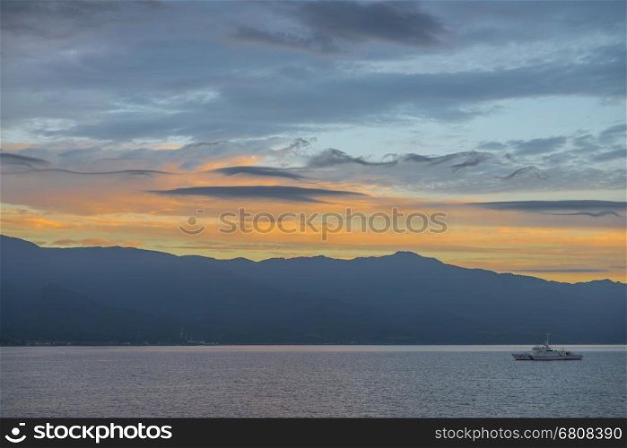 Niigata, Japan - August 12, 2014: Japan Coast Guard ship sailing in the bay of Sado island during sunrise,Nigata prefecture.