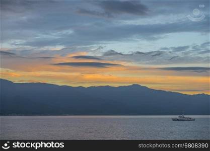 Niigata, Japan - August 12, 2014: Japan Coast Guard ship sailing in the bay of Sado island during sunrise,Nigata prefecture.