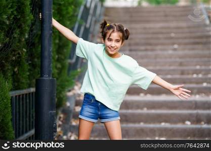 Nine-year-old girl playing with a street lamp in a park. Nine-year-old girl playing with a street lamp
