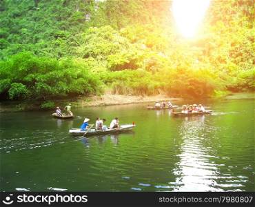 NINH BINH, VIETNAM, JULY, 20: Unidentified tourists in Trang An on JULY, 20, 2013. Trang An is the scenic area, ranked special of Vietnam.