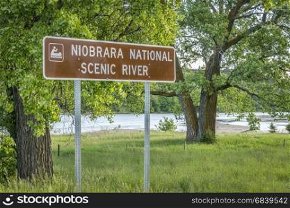 Niobrara National Scenic River road sign with a river in background, Nebraska Sand Hills