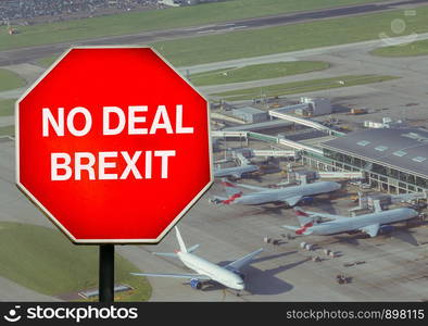 No Deal Brexit digital composite sign with high perspective view of airport terminal in background. UK is set to leave the EU by default on October 31st, 2019 leading to disruptions in travel. No Deal Brexit digital composite sign with high perspective view of airport terminal in background