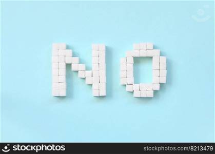 NO Letters of sugar cubes on a pastel blue background. Diabetic concept. Refusing sugar. Flat lay minimal top view. Refusing sugar sign with big letters on blue background