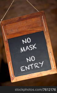 No Mask No Entry Coronavirus COVID-19 wooden blackboard or chalkboard menu sign hanging in a retail shop, restaurant or cafe