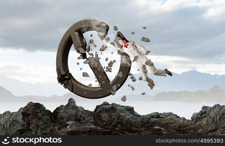 No more limits . Young emotional woman crashing prohibition stone sign