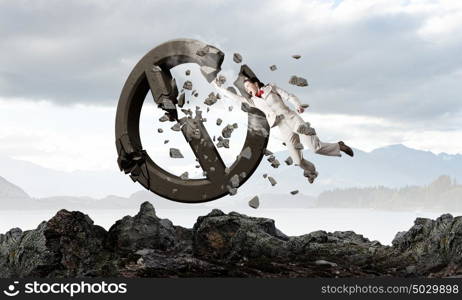 No more limits . Young emotional woman crashing prohibition stone sign