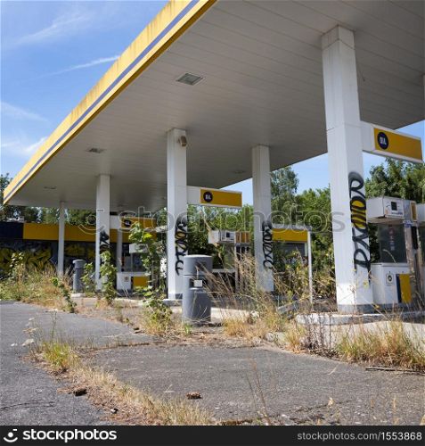 no more oil from this abandoned gas station in france with weeds and grass instead of cars