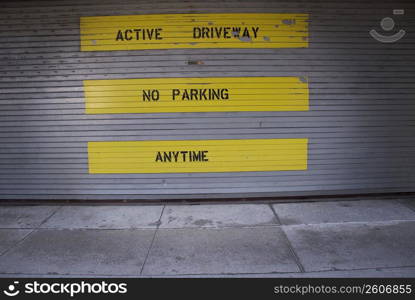No Parking Sign painted on a wall