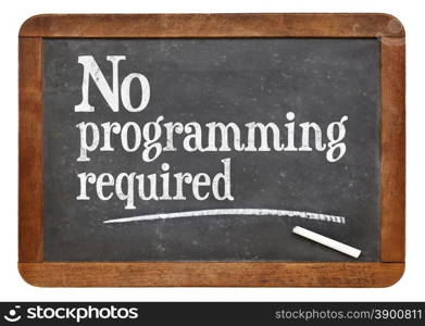 No programming required sign - white chalk text on a vintage slate blackboard