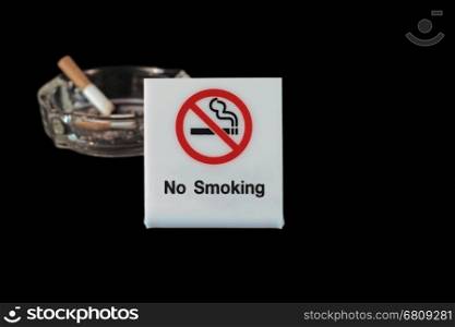 no smoking sign with ashtray and cigarette on black background