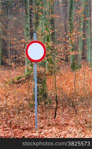No vehicles traffic sign in autumn forest in Poland. Misty autumnal day