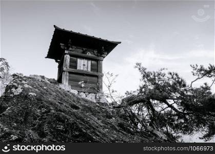 Nokyodo sutra repository building on rock cliff in evening at Yamadera Risshaku ji temple. Yamagata - Japan. Black and white image