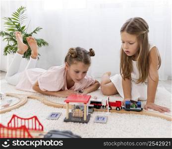 non binary children playing with cars game indoors 2
