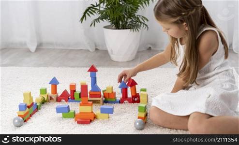 non binary kid playing with colorful game home