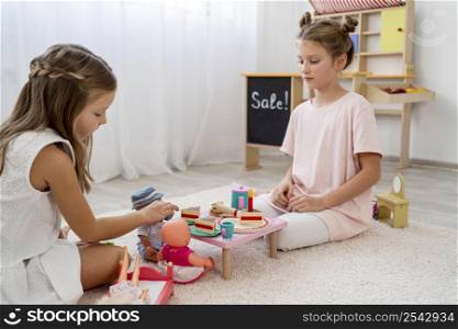 non binary kids playing birthday game with baby doll