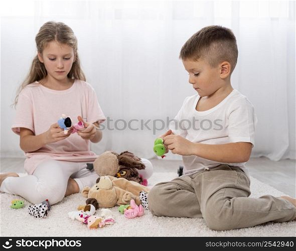non binary kids playing together indoors 2