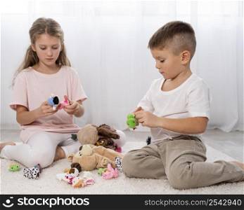 non binary kids playing together indoors 2
