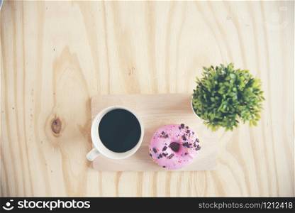 Non diet snack, strawberry donut and black coffee for chubby fat woman.