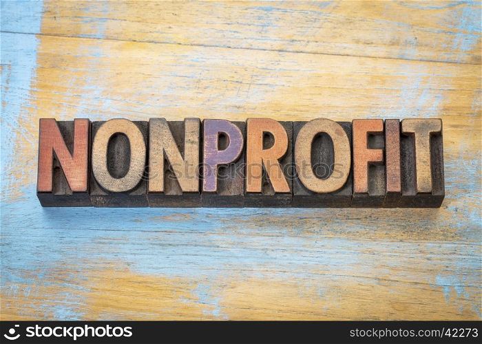 nonprofit banner - word abstract in vintage letterpress printing blocks stained by color inks