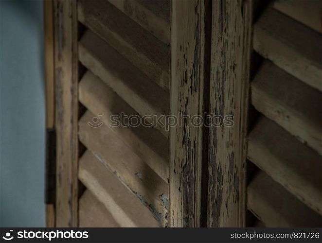 Nonthaburi, Thailand - JUL 21,2019 : Old wooden door pattern of the European style town hall The ancient white wooden house was left to deteriorate over time, when it was once a town hall.