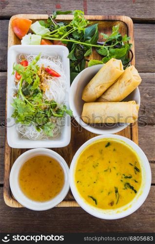 noodle and curry sauce with vegetable on wood table