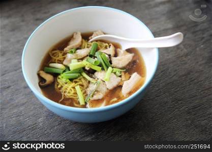 noodle with pork on wood background