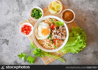 noodles bowl with boiled egg minced pork vegetable spring onion lemon lime lettuce celery and chili on table food , instant noodles cooking tasty eating with bowl noodle soup - top view 