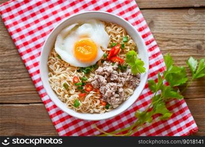 noodles bowl with boiled egg minced pork vegetable spring onion lemon lime lettuce celery and chili on table food , instant noodles cooking tasty eating with bowl noodle soup - top view
