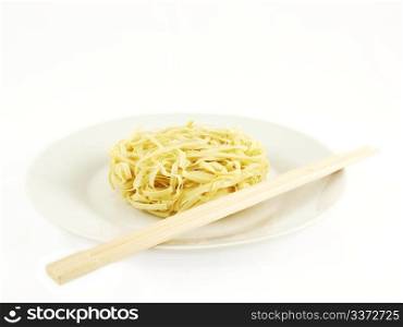 Noodles. Dried uncoocked noodles, on white plate with chopsticks, isolated towards white background