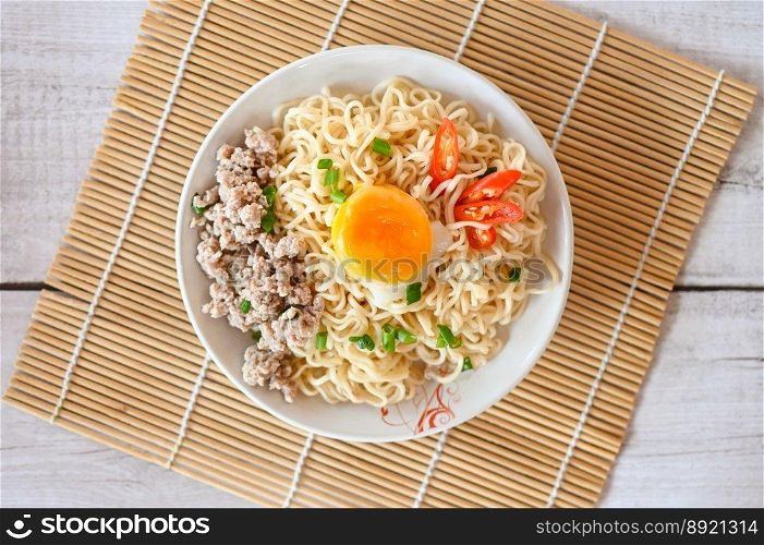noodles plate with egg minced pork vegetable spring onion celery and chili on table food , instant noodles cooking tasty eating with bowl noodle - top view