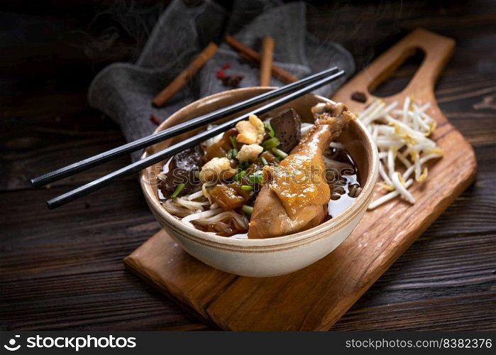 Noodles with chicken leg and chicken fillet, blood with soup Thai style and vegetable. Boat Noodles. Selective focus