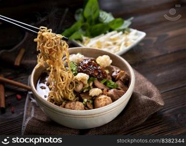 Noodles with pork and pork balls, chilli paste with soup Thai style and vegetable. Boat Noodles. Selective focus