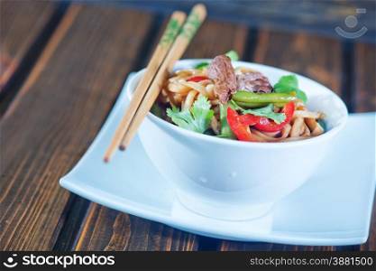 noodles with sauce and fried meat in bowl