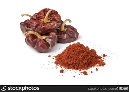 Nora, spanish dried peppers and a heap of ground powder isolated on white background