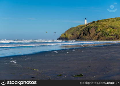 North Head Lighthouse at Pacific coast, Cape Disappointment, built in 1898, WA, USA. Coast guard helicopters in the sky.