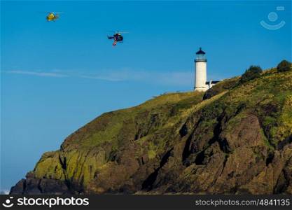 North Head Lighthouse at Pacific coast, Cape Disappointment, built in 1898, WA, USA. Coast guard helicopters in the sky.